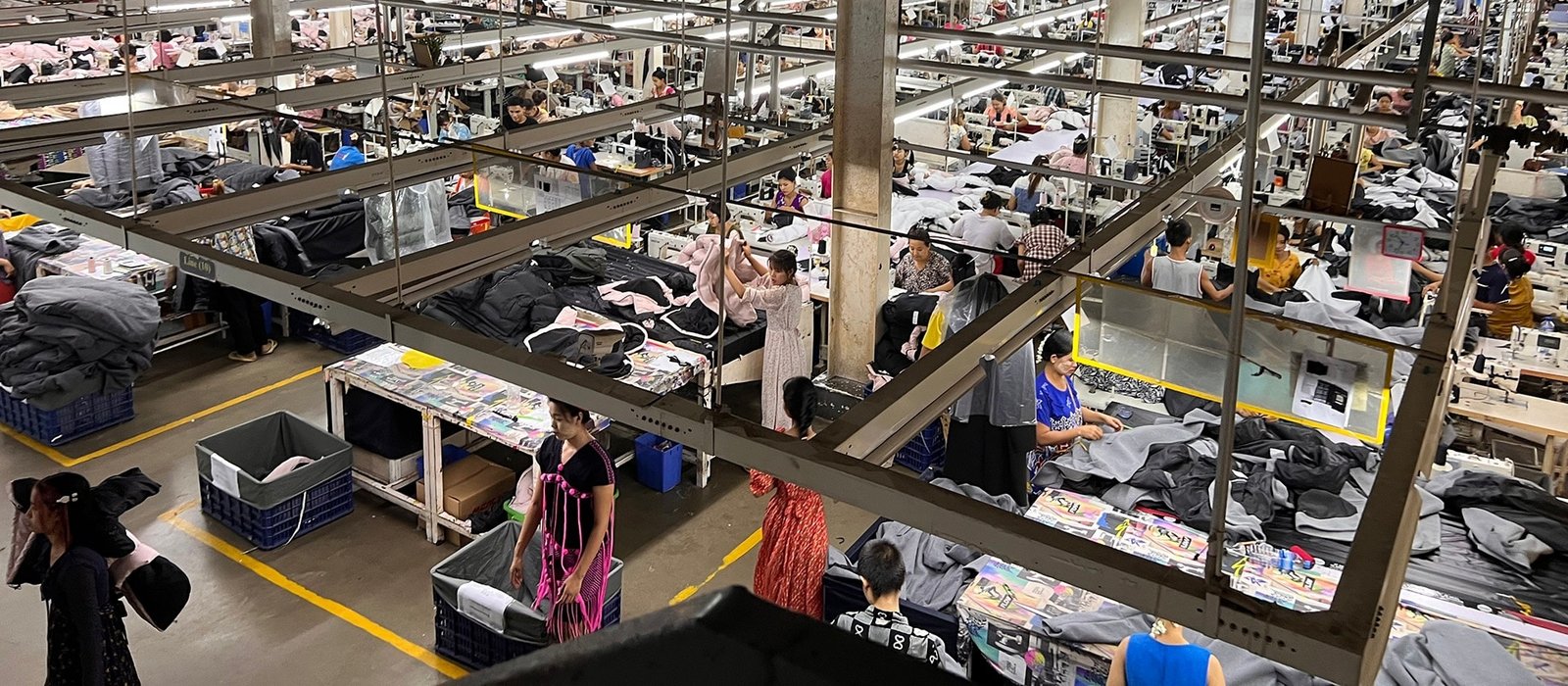Sewing operators producing custom garments on an apparel manufacturing floor