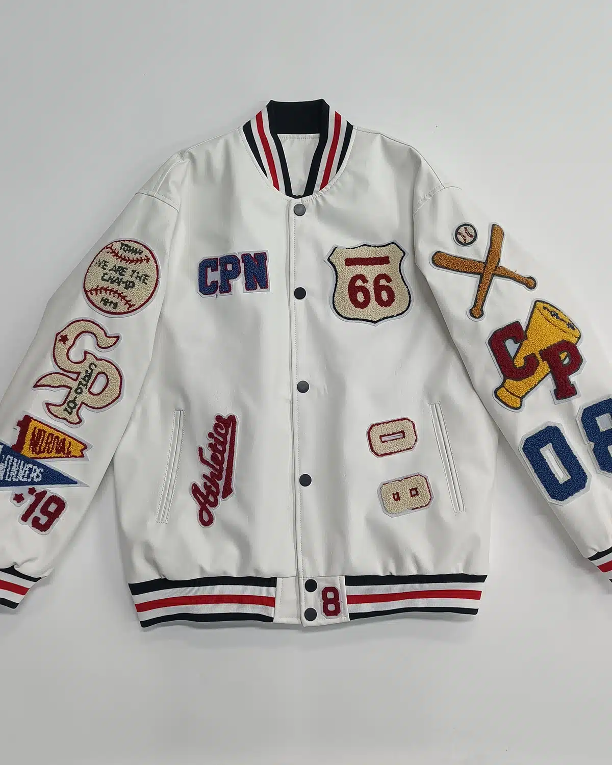 White varsity jacket with embroidered patches, striped ribbing and snap button closure